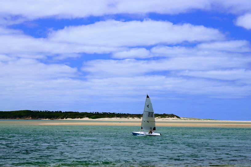 A luxurious sailboat gliding through calm ocean waters.
