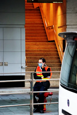 A friendly customer service representative wearing a safety vest, ready to assist via phone and chat.