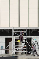 Safety inspection being conducted on scaffolding at an industrial maintenance site.