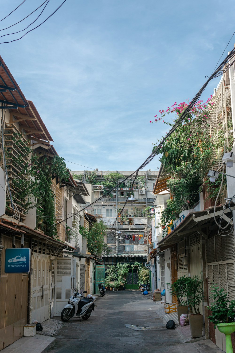 a narrow street with a motorcycle parked on the side of it