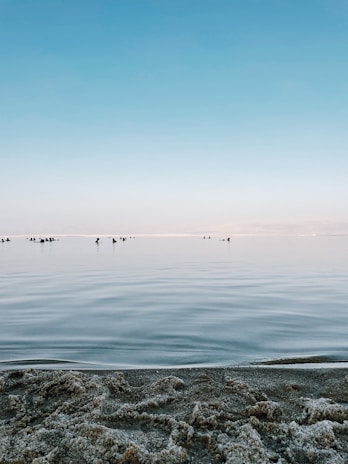 A tranquil beach scene with people enjoying the sun.