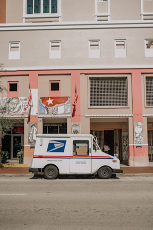 a mail truck parked in front of a building