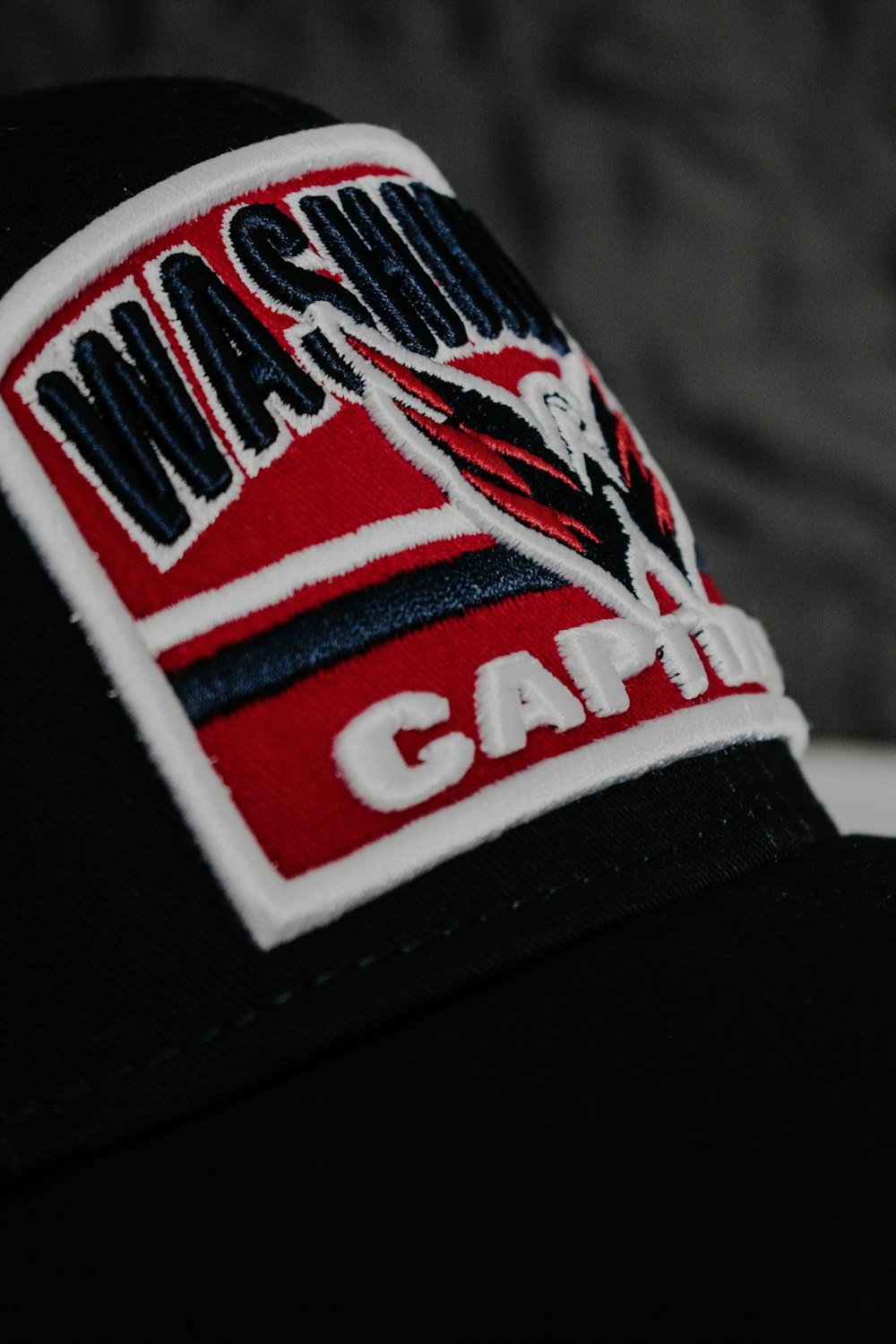 a black hat with a red and white patch on it