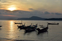 a group of boats floating on top of a body of water
