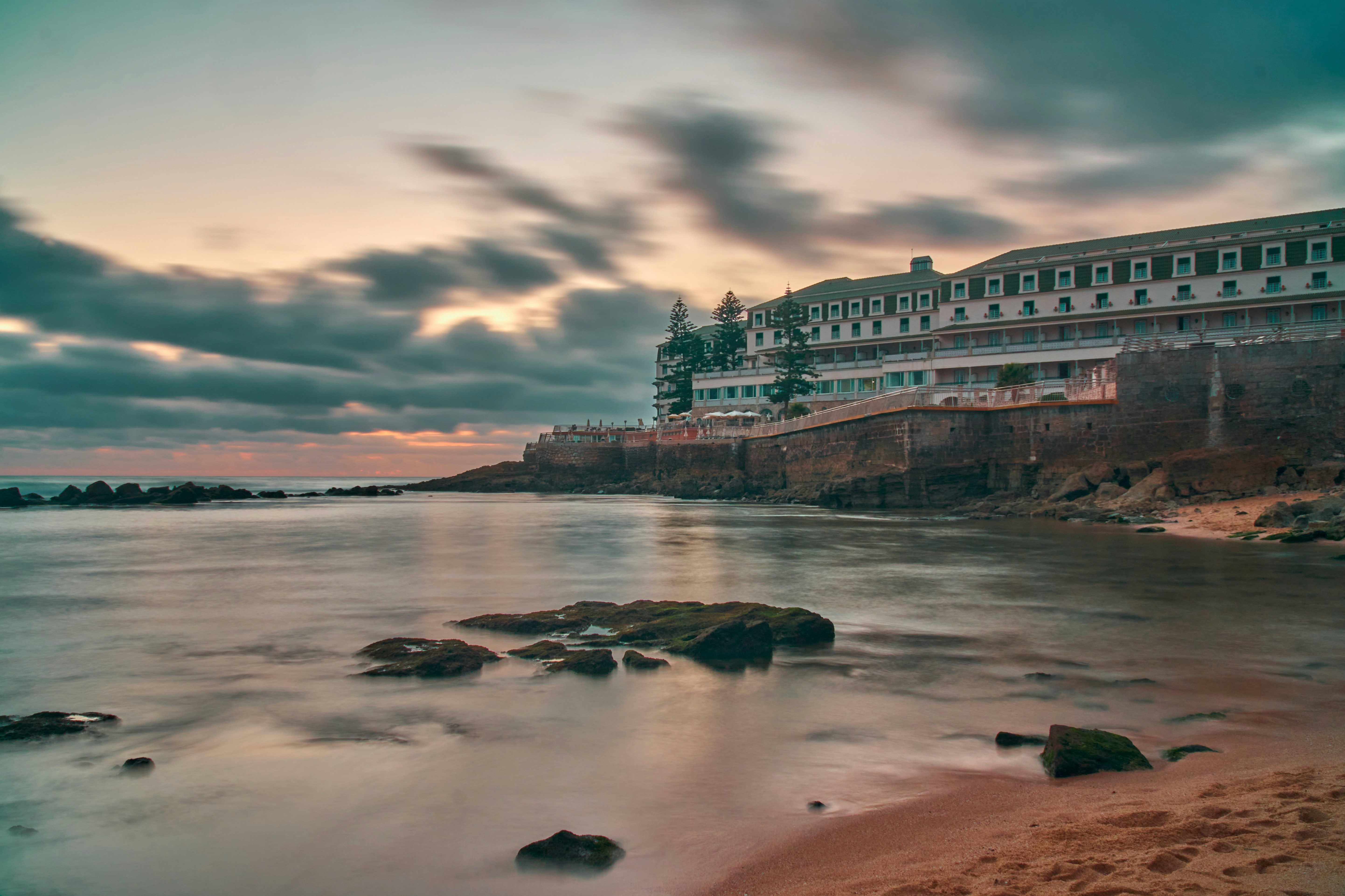 a long exposure photo of a hotel on the beach, Vila Galé in Ericeira during a sunset