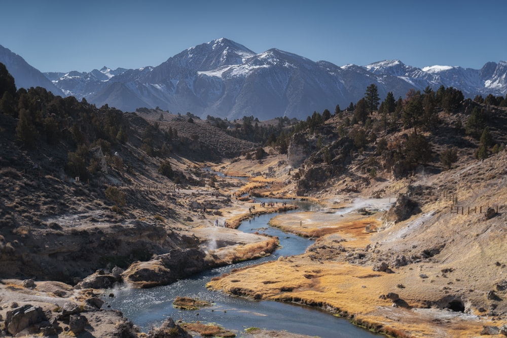 a river running through a valley surrounded by mountains