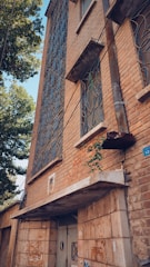 Hostel exterior showing a brick facade with plants