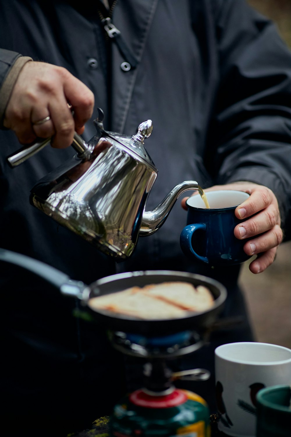 a man pours a cup of coffee