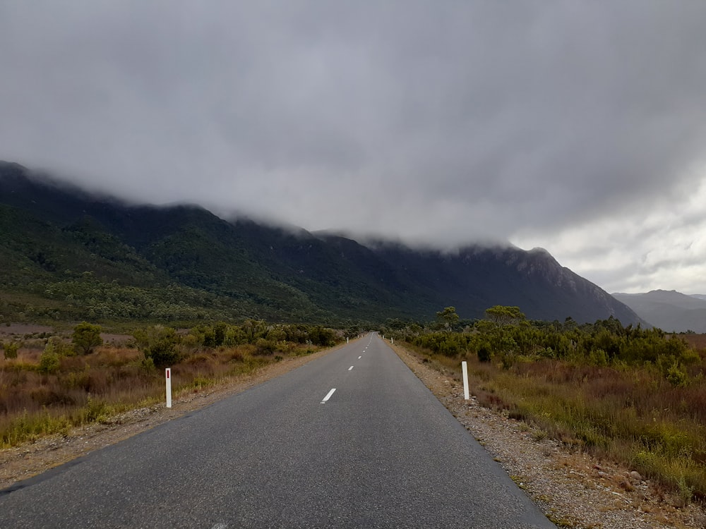 a long road with a mountain in the background