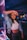 a beautiful young woman standing next to a neon sign