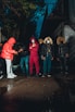 a group of people standing around each other