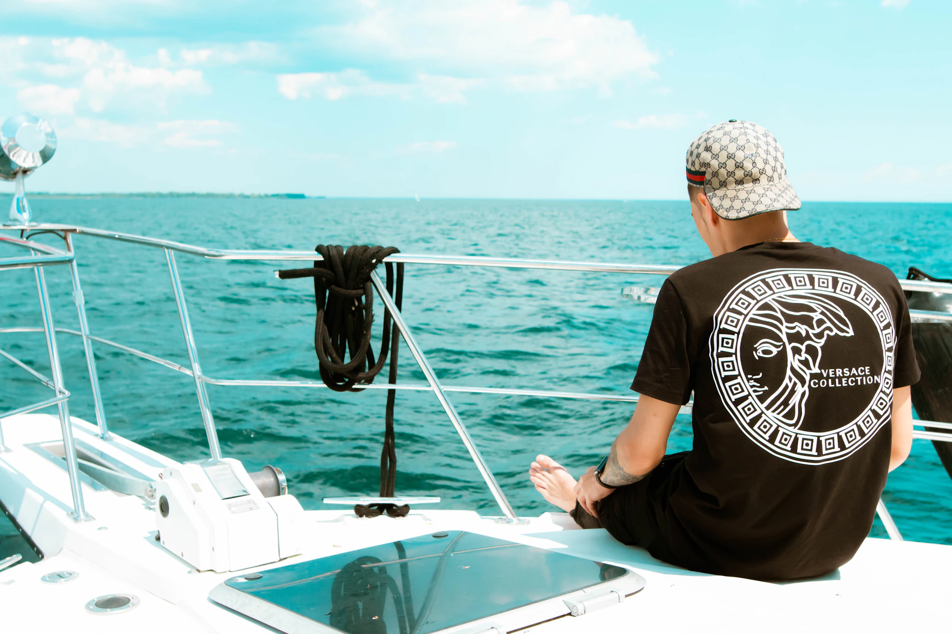 a man sitting on a boat looking out at the ocean