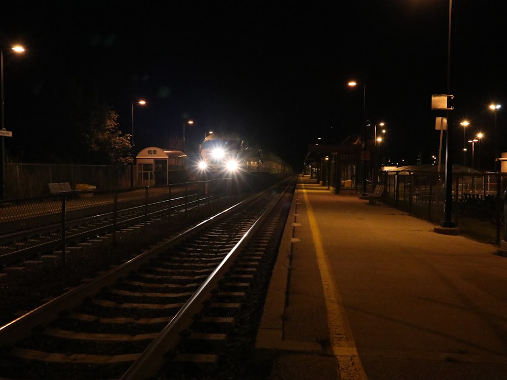 a train on a train track at night