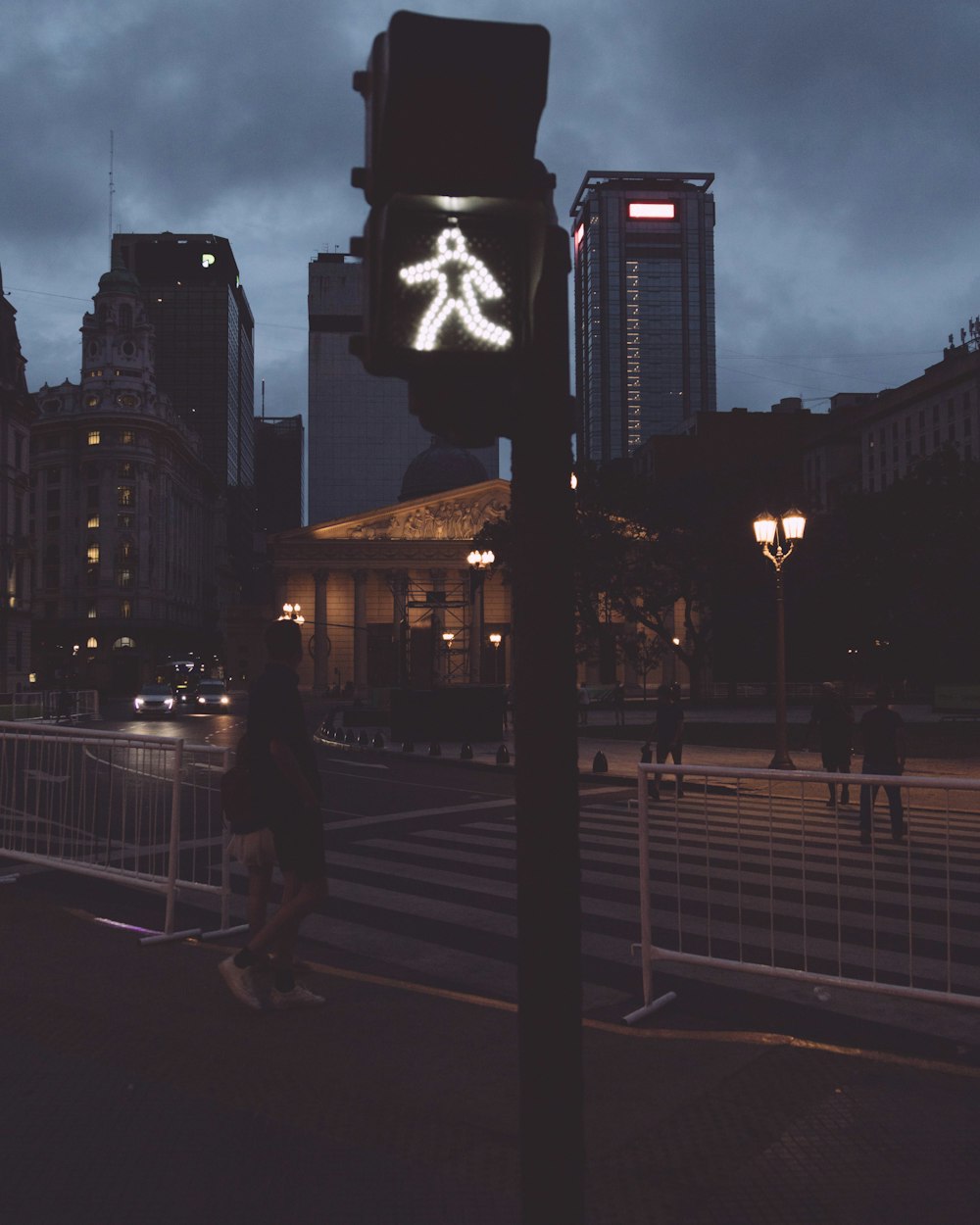 a pedestrian crossing sign on a city street