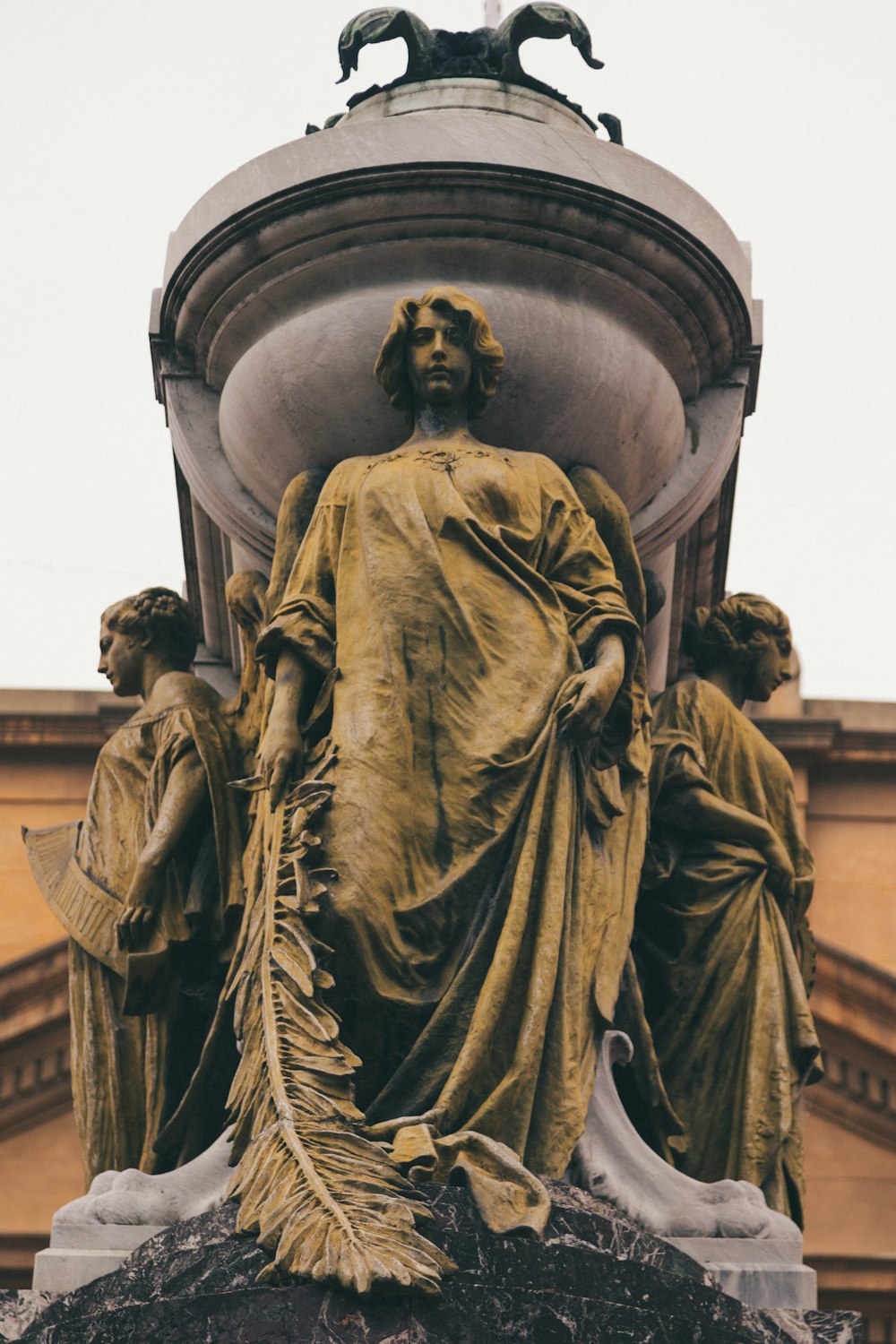 a statue of a woman surrounded by other statues