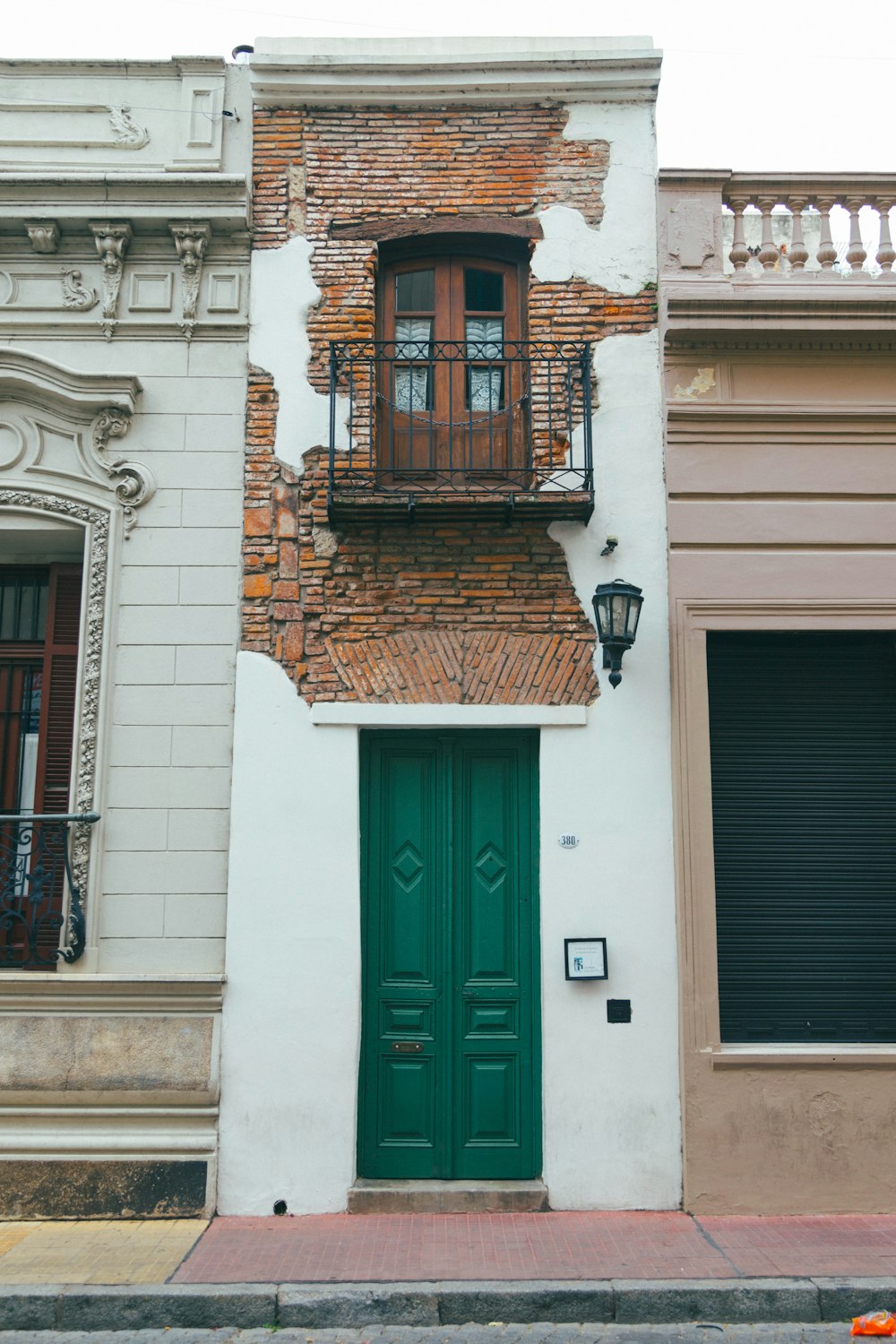 a building with a green door and window