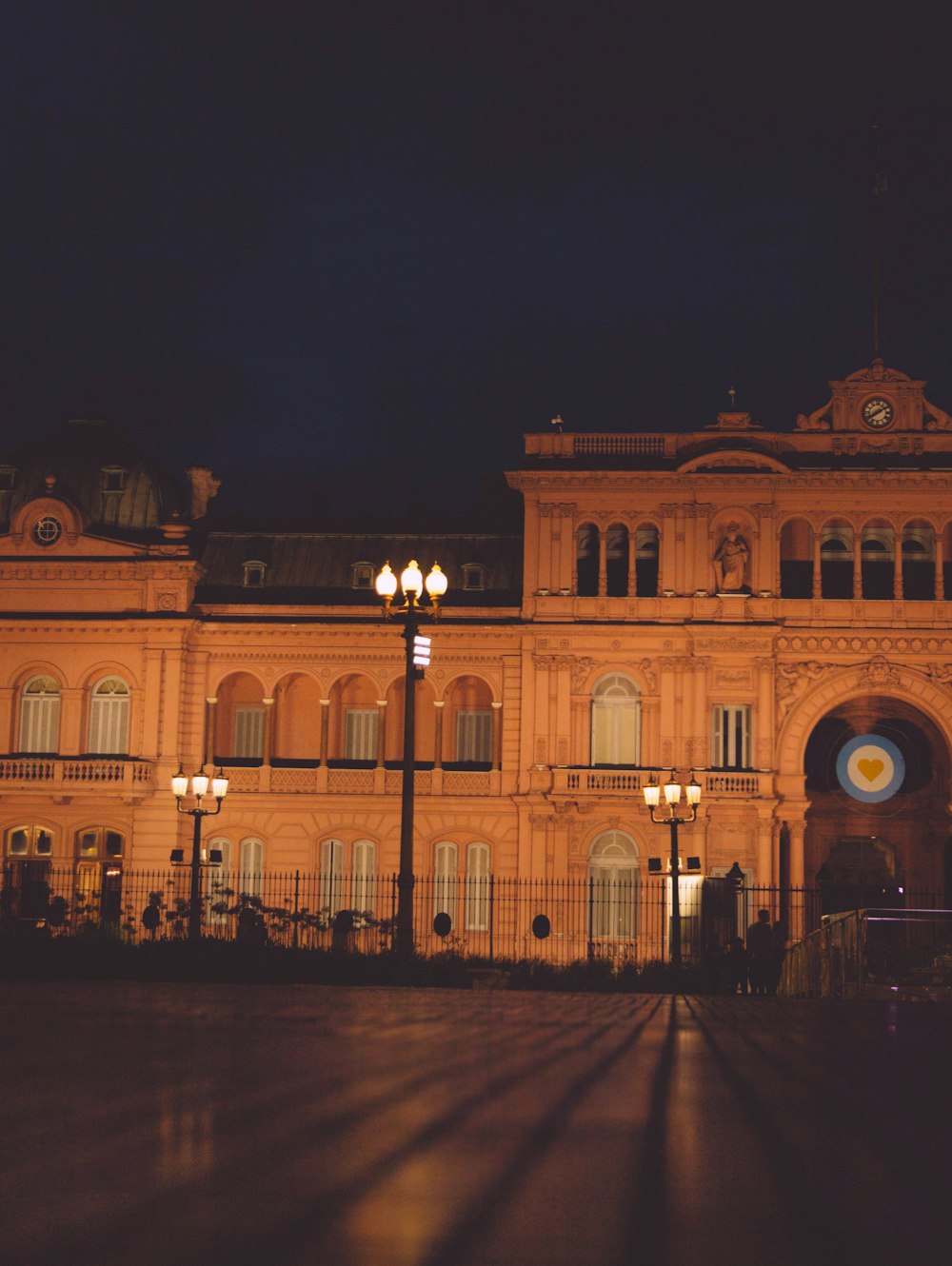 a large building lit up at night with street lights