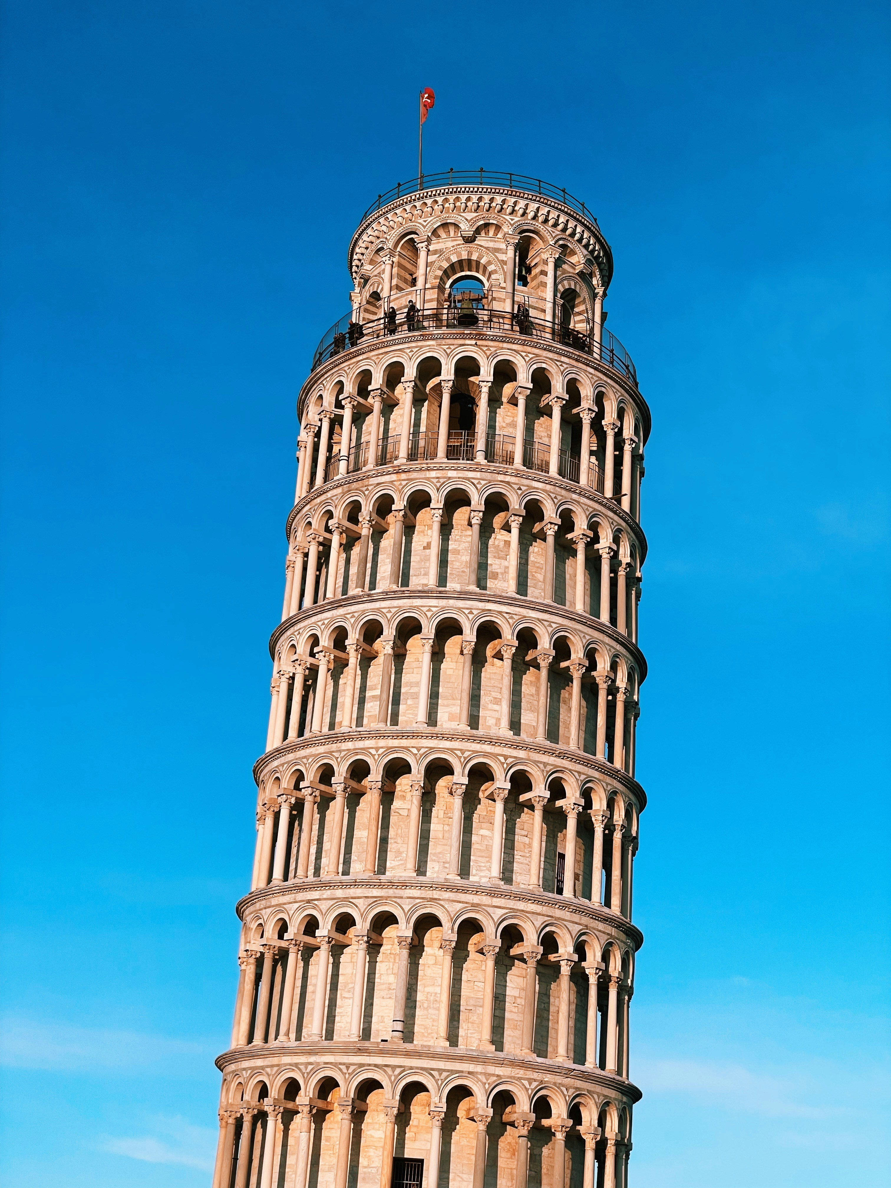 a very tall tower with a flag on top of it