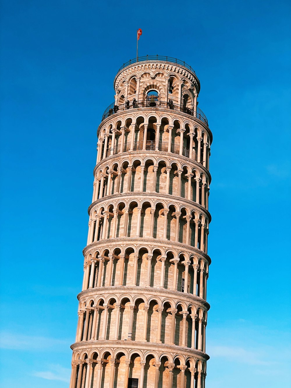 a very tall tower with a flag on top of it