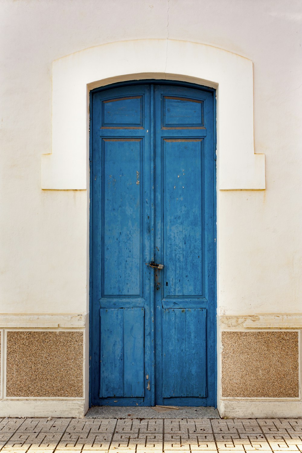 a blue door is open on a white building