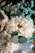 A detailed arrangement of flowers featuring predominantly white and blue tones. The central focus includes a large white chrysanthemum with a yellow center surrounded by smaller bright blue flowers and greenery, including eucalyptus leaves. The arrangement is complemented by lace and ribbon accents, creating a delicate and fresh appearance.