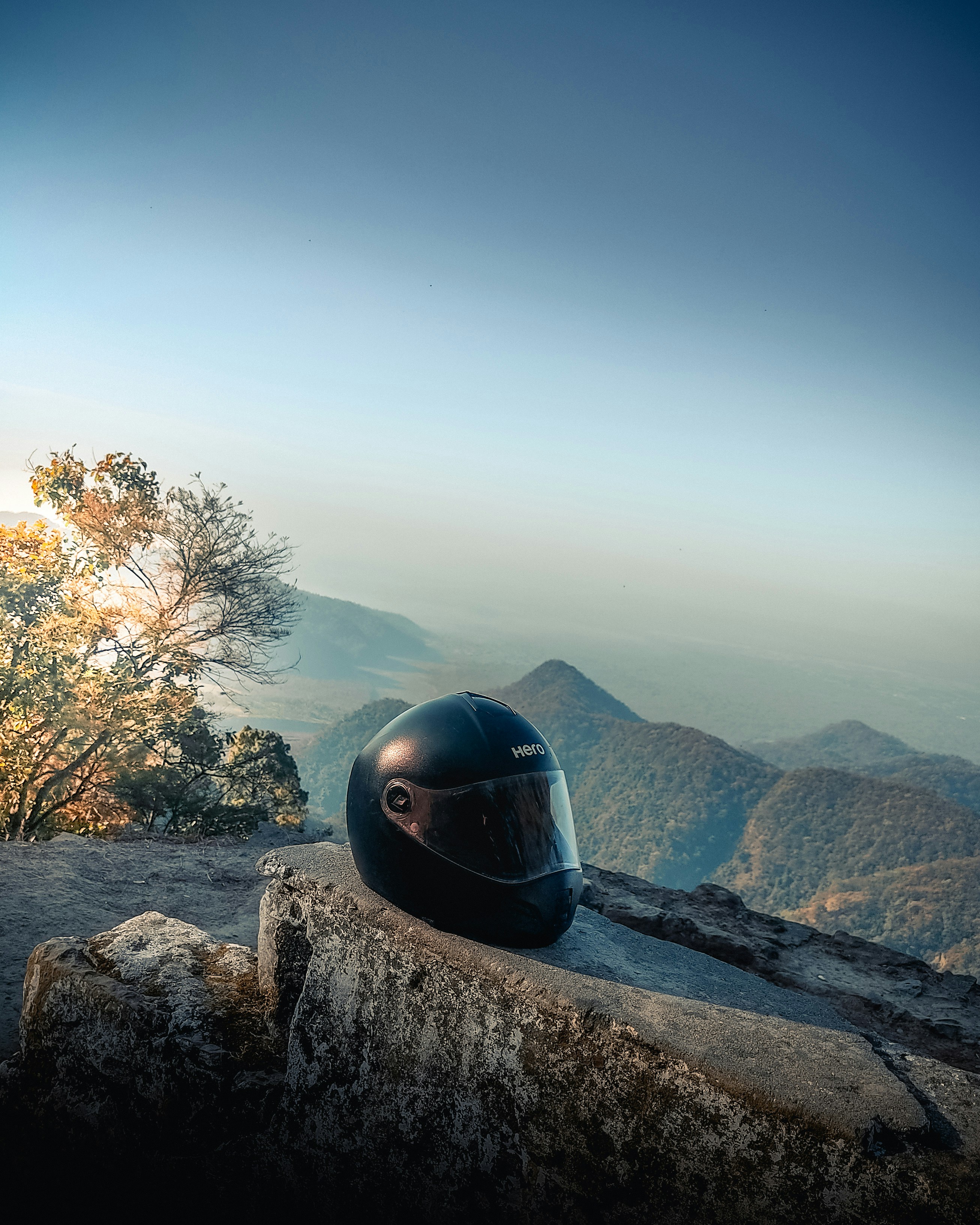 a motorcycle helmet sitting on top of a rock