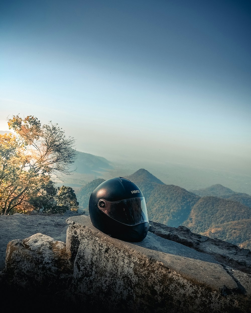 a motorcycle helmet sitting on top of a rock