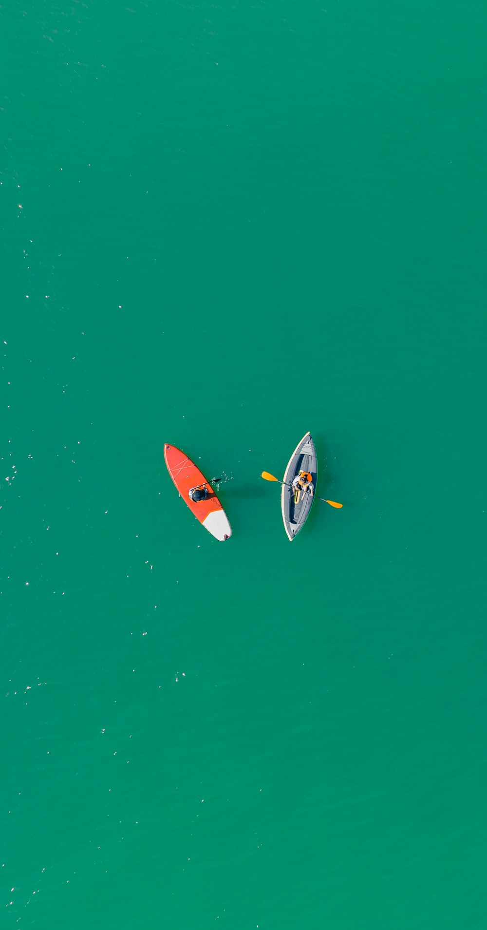 a couple of people riding on top of a boat in the ocean