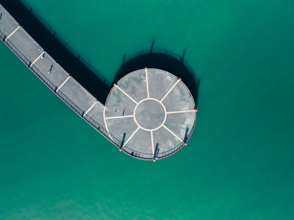 an aerial view of a pier in the water