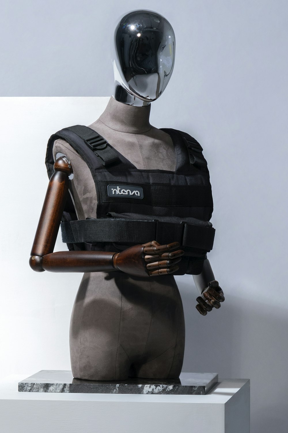 a mannequin wearing a body armor and holding a baseball bat
