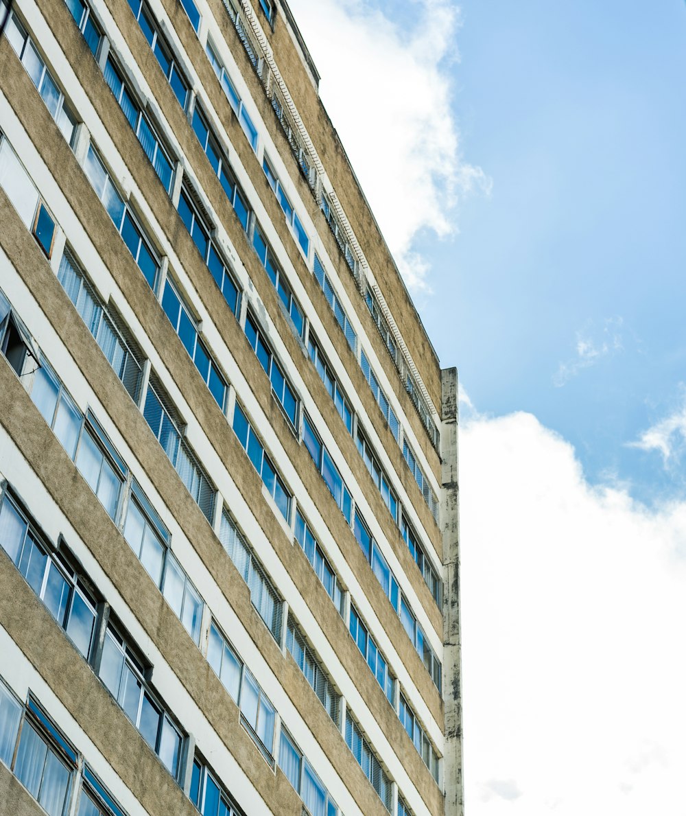 a tall building with many windows and a sky background