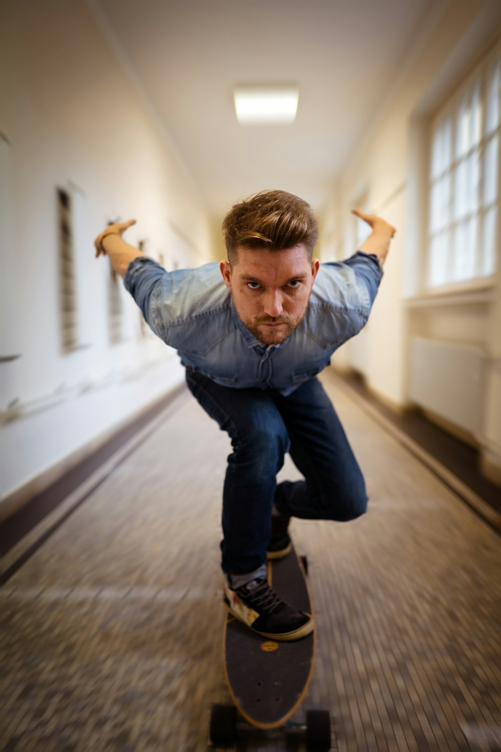 a man riding a skateboard down a hallway