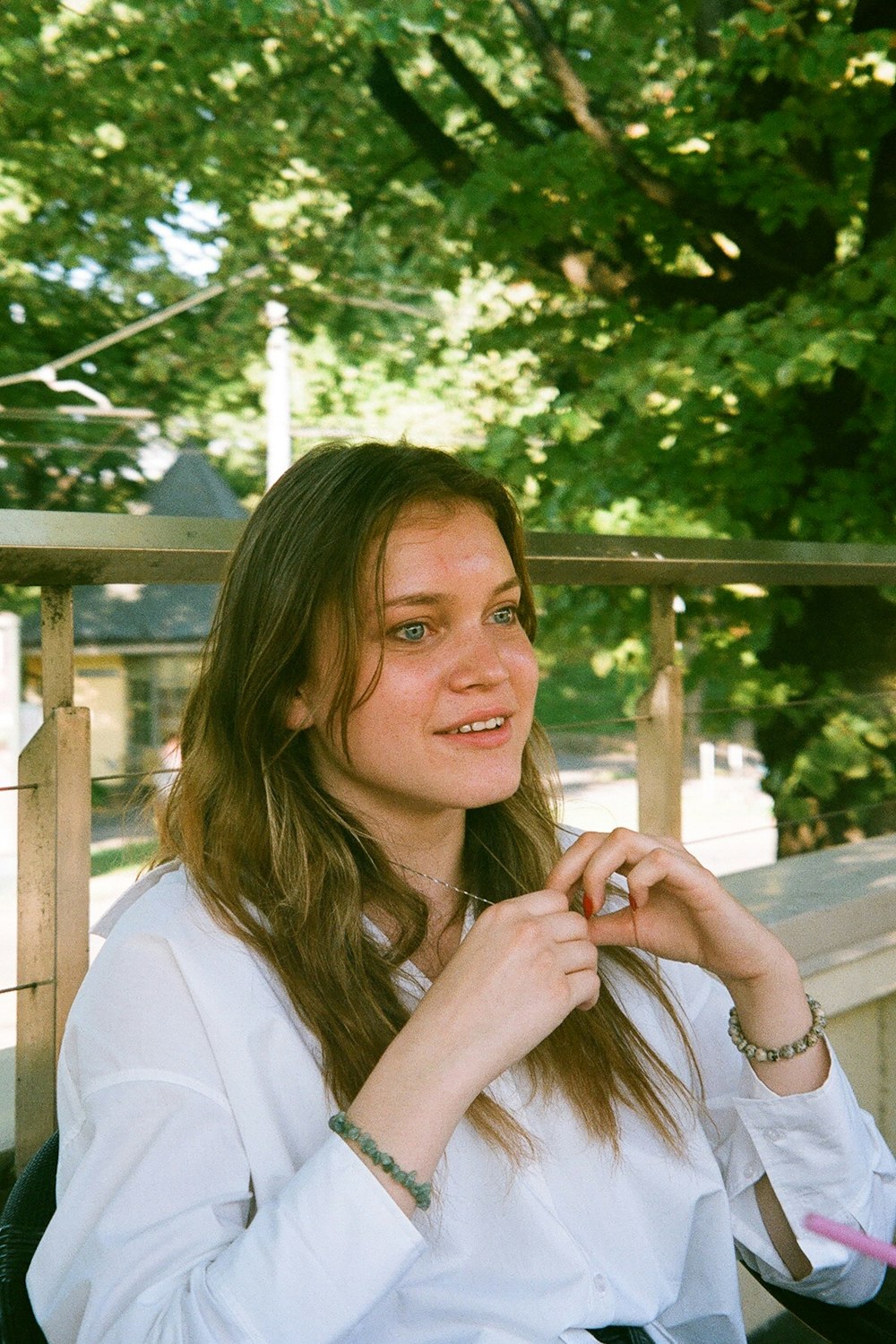 a woman sitting on a bench with a cigarette in her hand