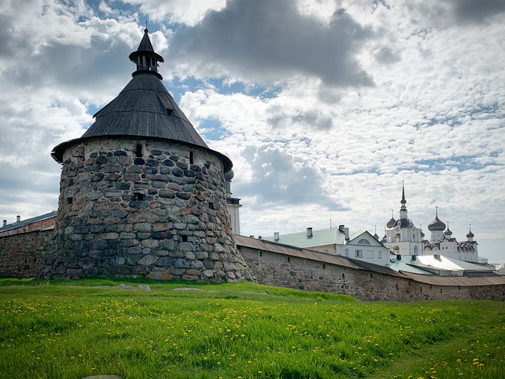 a stone building with a steeple on a cloudy day