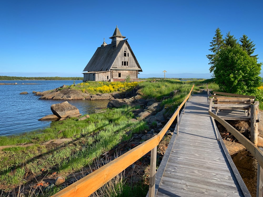 a wooden walkway leading to a wooden house