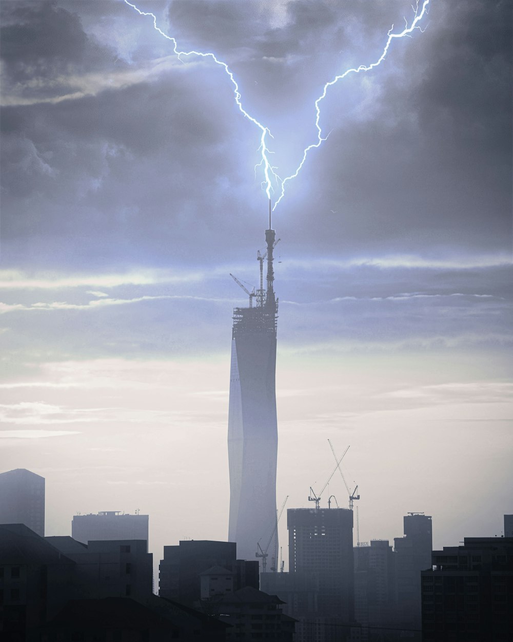 a tall building with a lightning bolt in the sky