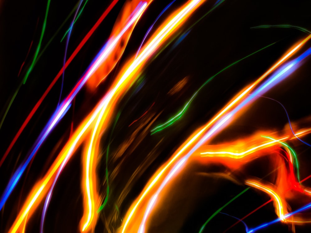 a blurry photo of a black background with colorful lights