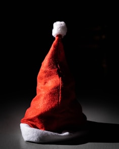 a red santa hat sitting on top of a table