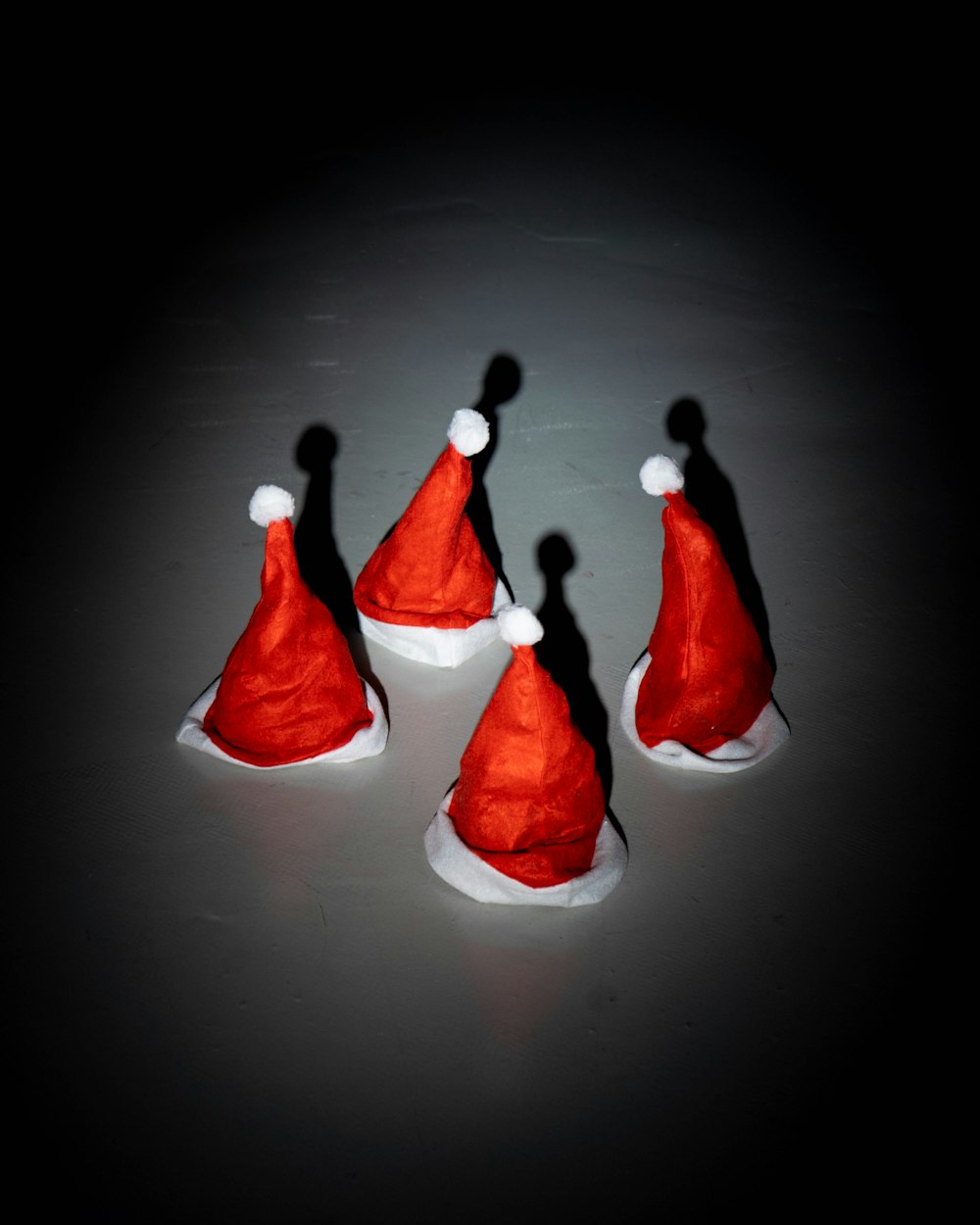 a group of red santa hats sitting on top of a table