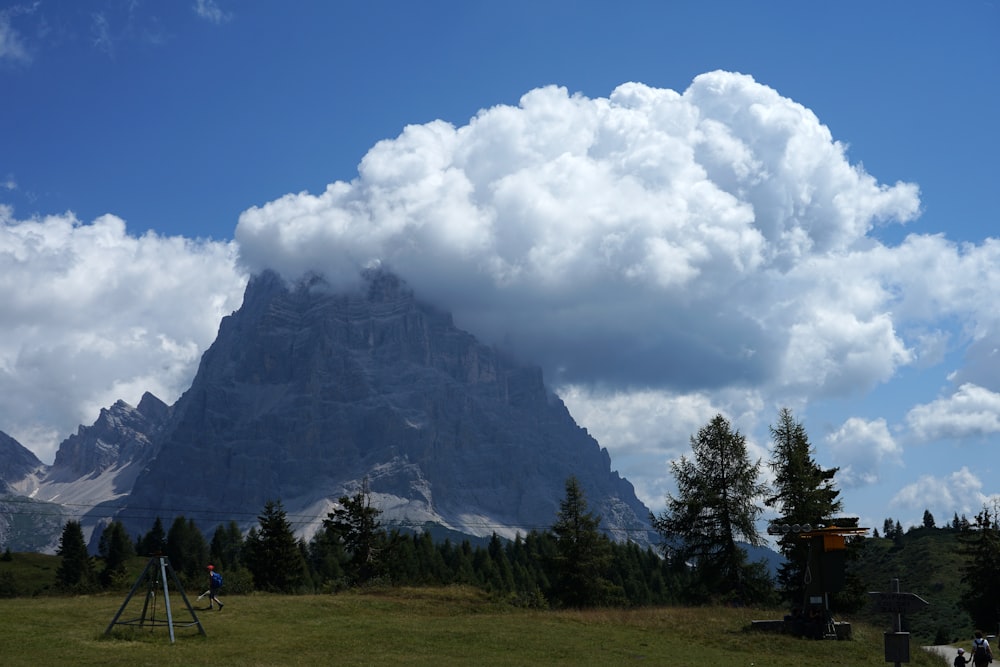 a large mountain is in the background with clouds in the sky