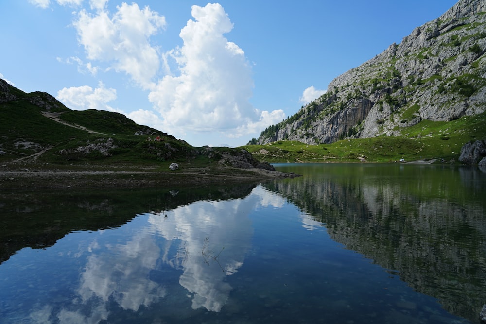 a body of water with a mountain in the background