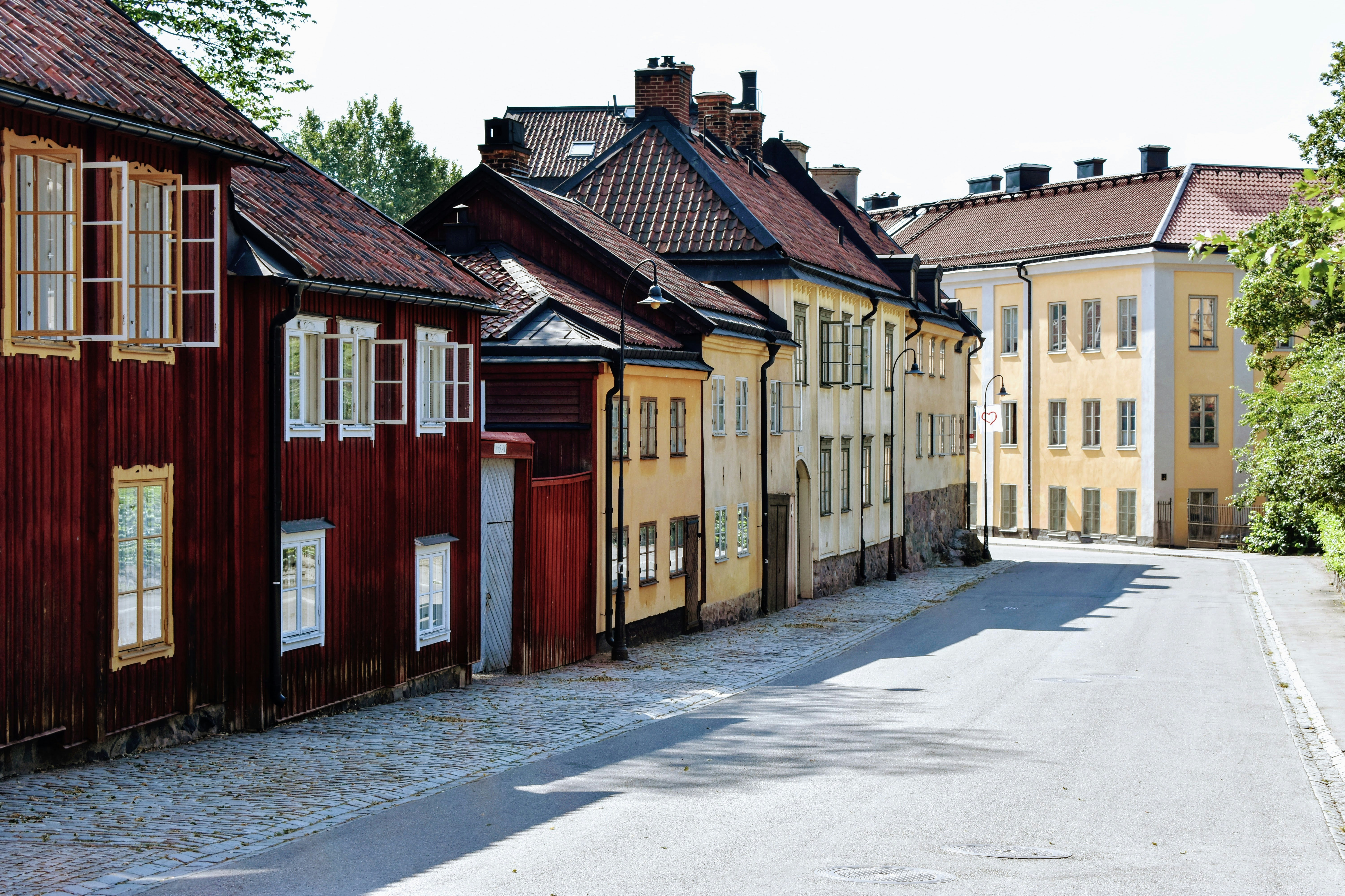 a street lined with wooden buildings next to trees