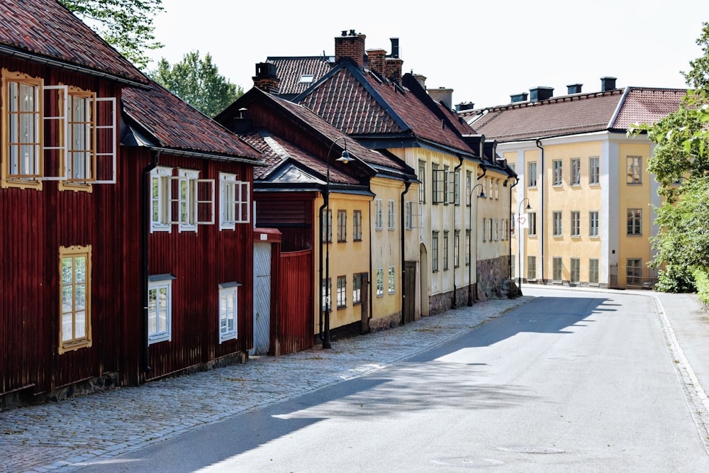 a street lined with wooden buildings next to trees