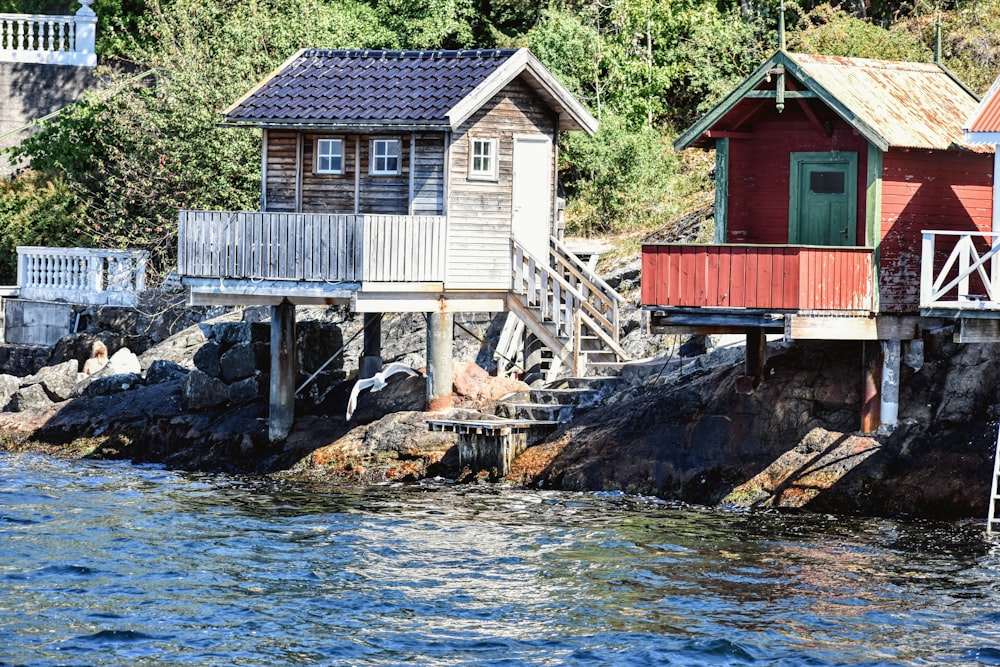 a group of houses sitting on top of a body of water