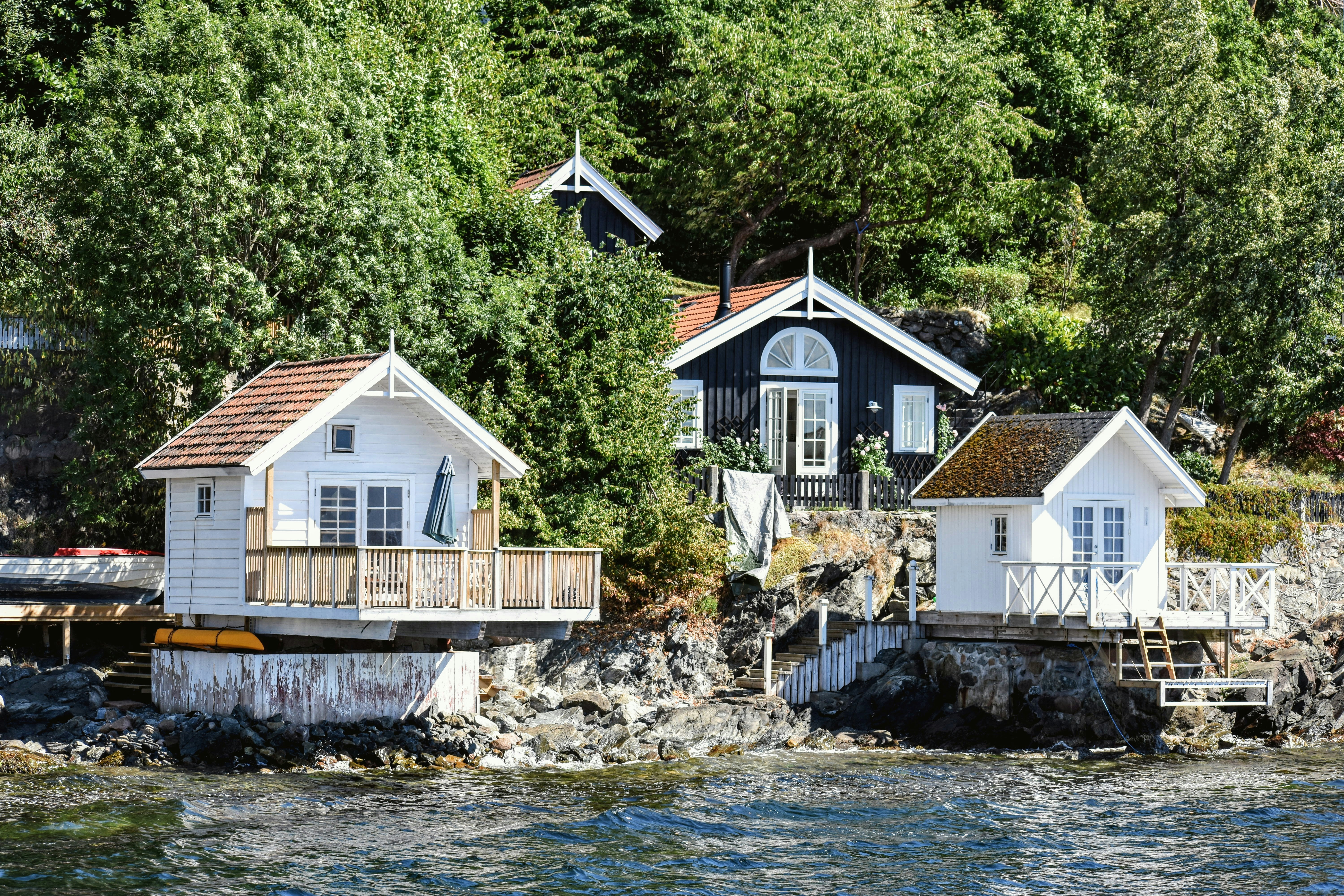 a couple of houses sitting on top of a body of water