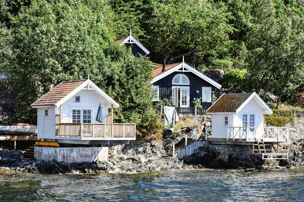 a couple of houses sitting on top of a body of water