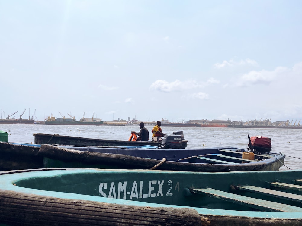 a couple of small boats floating on top of a body of water