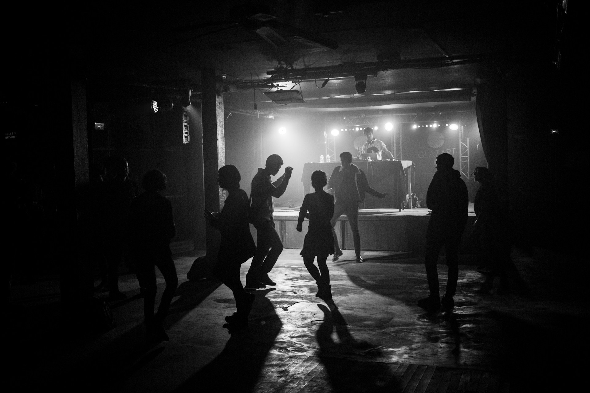 a group of people standing around in a dark room