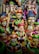A collection of colorful, intricately designed statues depicting various deities and figures from Indian mythology. The statues feature detailed carvings and vibrant colors, with elements representing traditional musical instruments and symbolic gestures.