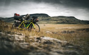 a yellow and black bike parked in a field